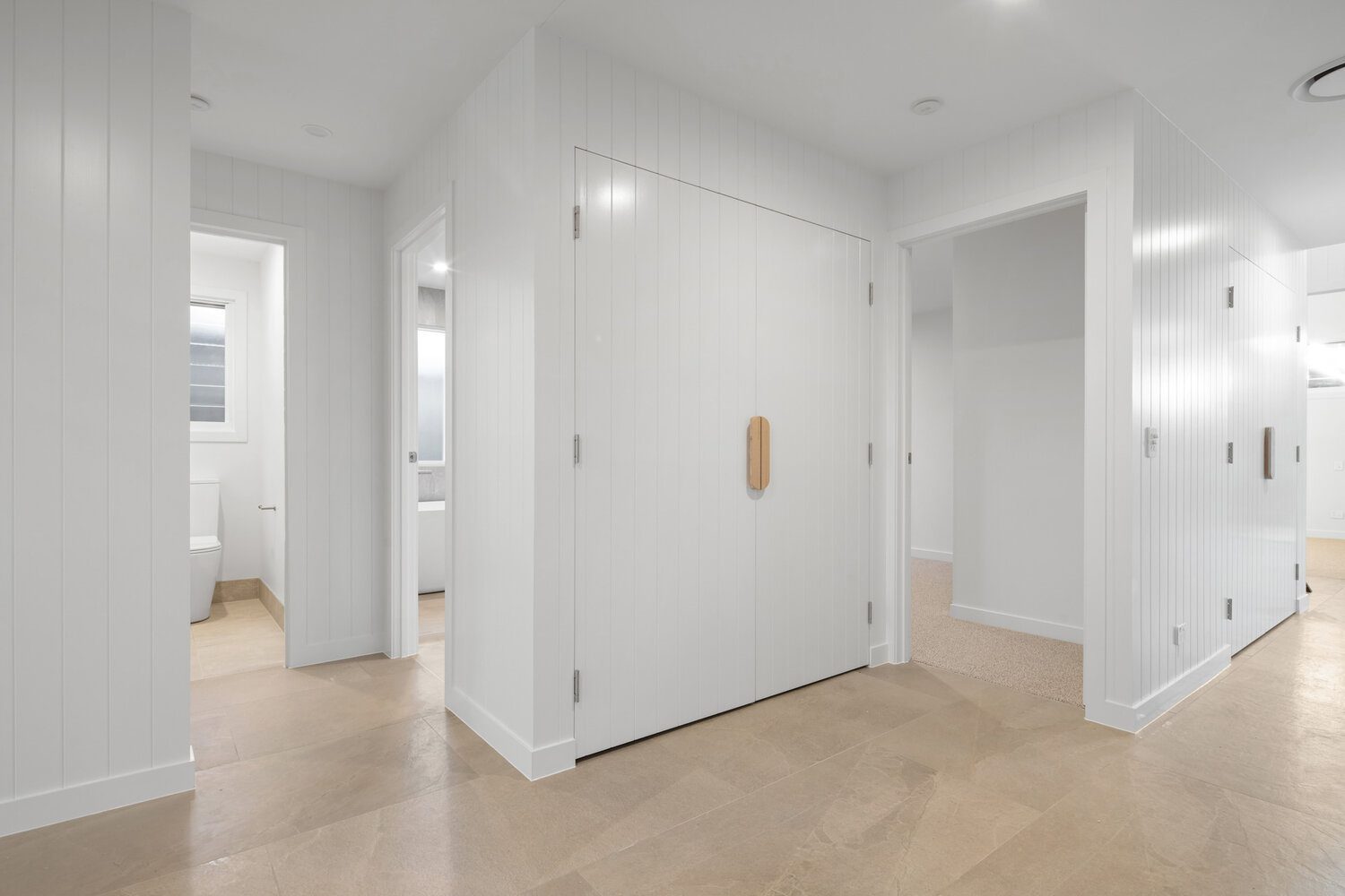 Entry hall with stone-look floor tiles and VJ panelling